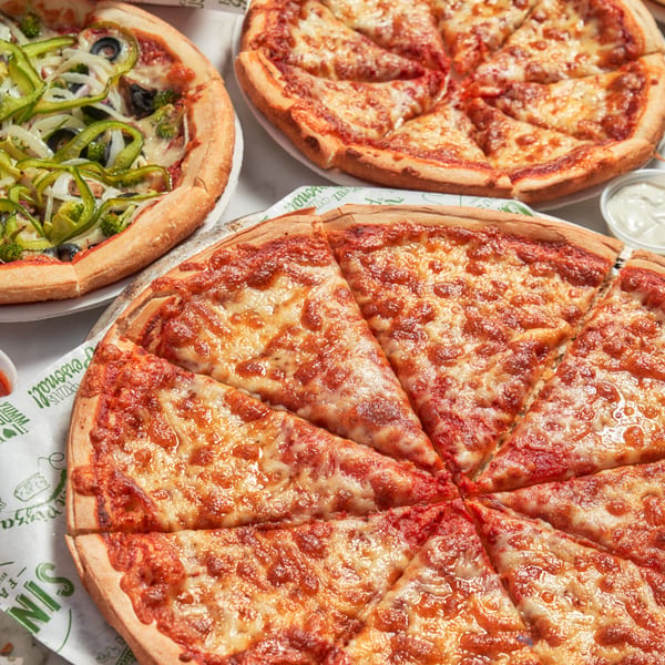 Three Singas Famous Pizzas, including a cheese pizza and a vegetable pizza with green peppers.