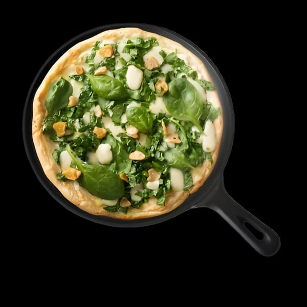Spinach and garlic pizza with white sauce in a black pan from Singas Famous Pizza.